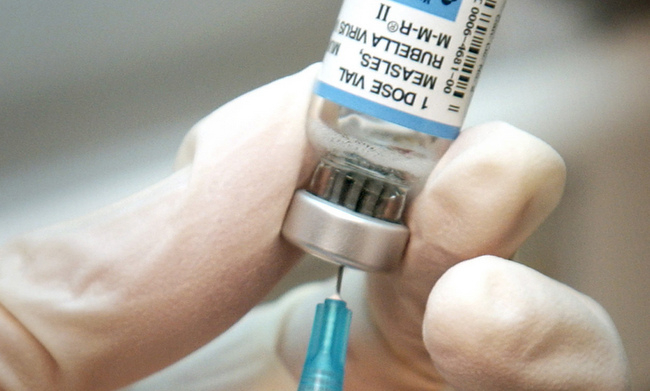 A nurse draws a dose of mumps-measles-rubella, or MMR, vaccine. A major measles outbreak traced to Disneyland has brought criticism down on the small but vocal movement among parents to opt out of vaccinations for their children. (AP Photo/The Wichita Eagle, Mike Hutmacher, 2006 file)