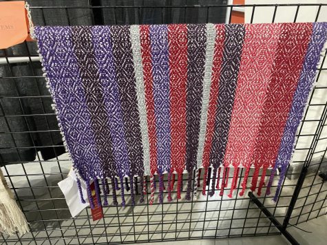 Colorful weaving with award ribbons attached.